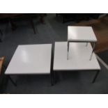 Three retro occasional tables, each with a white Formic top on a chrome underframe and square