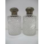 A pair of Victorian silver and clear glass scent bottles by William Comyns & Sons, London 1883, each