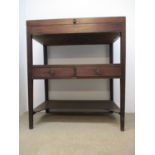 A Regency ebony, string inlaid mahogany side table with hinged top over a shelf with two drawers, on