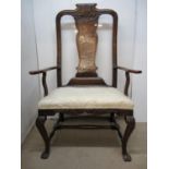 A large mid 18th century oak carver chair with a carved crest, splat back and shaped arms with S