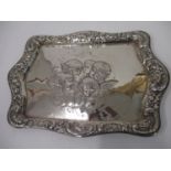 A silver dressing table tray by Henry Mathews 1896, Birmingham in embossed and chased with a