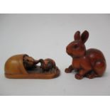 Two Chinese carved wooden netsuke, one in the form of a rabbit with a signature to the base and