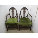 A pair of George III mahogany framed carver chairs, each with an oval, pierced splat back, inlaid