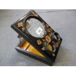 An early 20th century ebonized and floral painted view finder