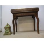 A 20th century West Asian mix veneered games table, with a rotating fold-over top, enclosing a