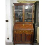 A George III and later ebony and boxwood inlaid, mahogany bureau bookcase, with a dentil moulded