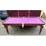 A Victorian walnut slate bed billiards/dining table with three removable leaves revealing a purple