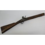 An early 19th century Indian Flintlock carbine with a 16 1/8" barrel, the lock-plate stamped with an