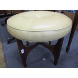 A retro teak stool with circular cream leather seat