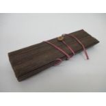 A 19th century South East Asian Buddhist manuscript on palm leaves, with wooden covers, 11 1/2" l