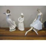 Two Lladro figures, a ballerina sat on a rock, and a woman holding on her hat, and a Nao figure of a