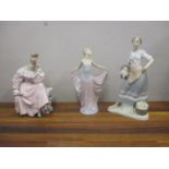 Three Lladro figures, a woman sat on a bench holding a fan, a woman dancing and a woman holding a