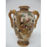 A late 19th/20th century Satsuma vase of ovoid form with a flared lip and twin gilt handles,