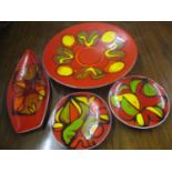 Four Poole pottery Delphis pattern plates to include a large charger