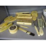 A Victorian ivory dressing table brush set comprising a hand mirror and four brushes, each with a