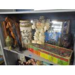 A mixed lot to include a boxed horse racing fame, chessboard, tribal busts, mirrors and other items