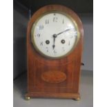 An Edwardian domed topped mantle clock having a white enamel dial and fitted with an eight day