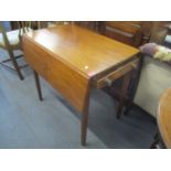 An early 19th century mahogany Pembroke table having inset drawer and square legs