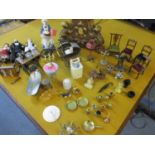 A quantity of metal dolls house furniture and accessories to include a sewing machine, a vacuum