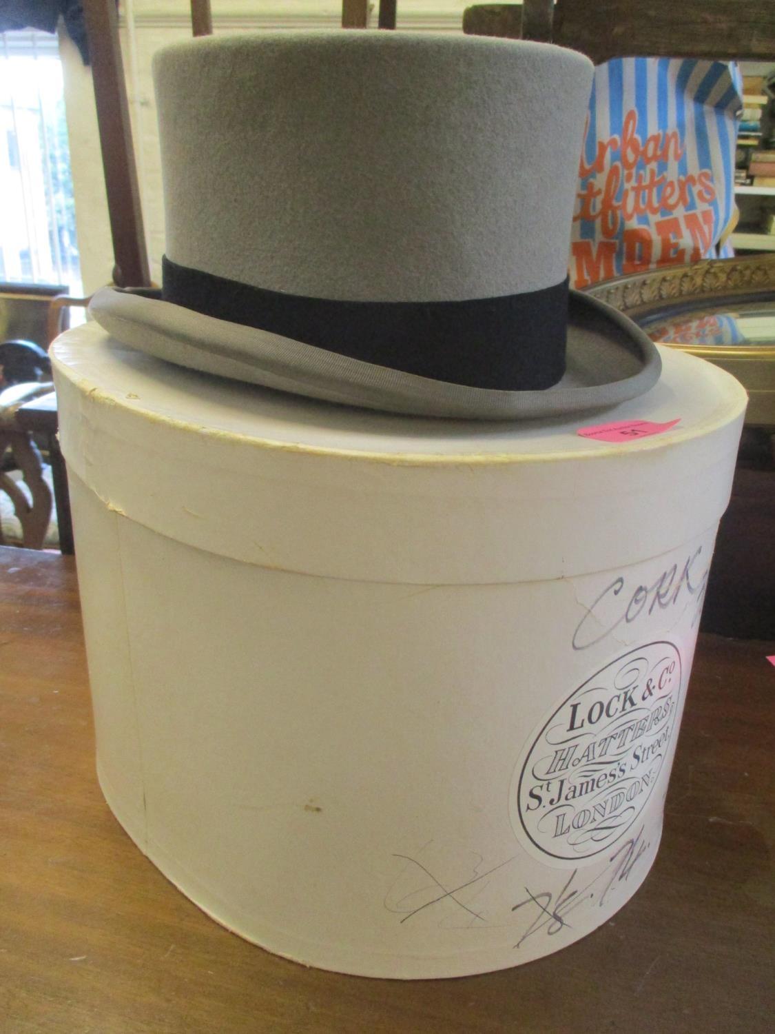 A Moss Bros top hat size 7.5 with hat box