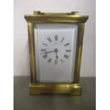 An early 20th century brass cased carriage clock having white enamel dial and blued hands