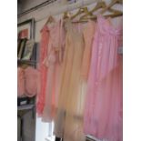 A quantity of pink and peach coloured mid 20th century ladies nightwear to include a White House