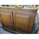 A late Victorian mahogany twin door cabinet on a plinth base A/F