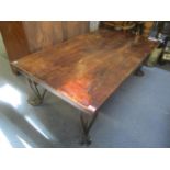 A modern teak topped coffee table on wrought iron supports, 18" h x 53 1/2"w