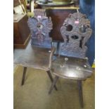 Two 19th century continental oak carved hall chairs