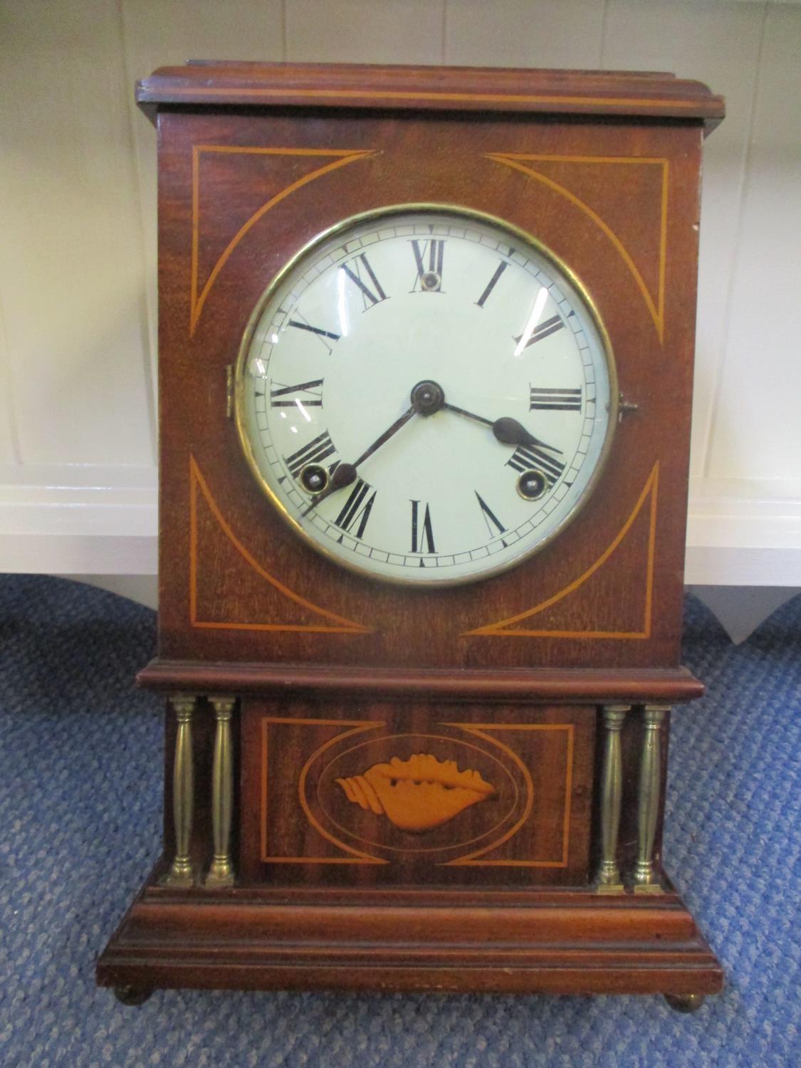 An Edwardian mahogany Sheraton revival mantle clock fitted with an 8 day movement, whit dial with