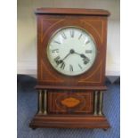 An Edwardian mahogany Sheraton revival mantle clock fitted with an 8 day movement, whit dial with