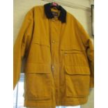 A Daks gents outdoor padded jacket with orange material having a black collar, size large