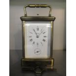 A 20th century brass repeater alarm, carriage clock, the white enamel dial signed Angelus, having