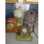 Four clocks to include a cuckoo clock, anniversary clock and two mantle clocks