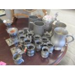 A mixed lot to include pewter tankards and a pair of silver plated candlesticks