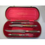 An antler and silver ferrules cased carving set