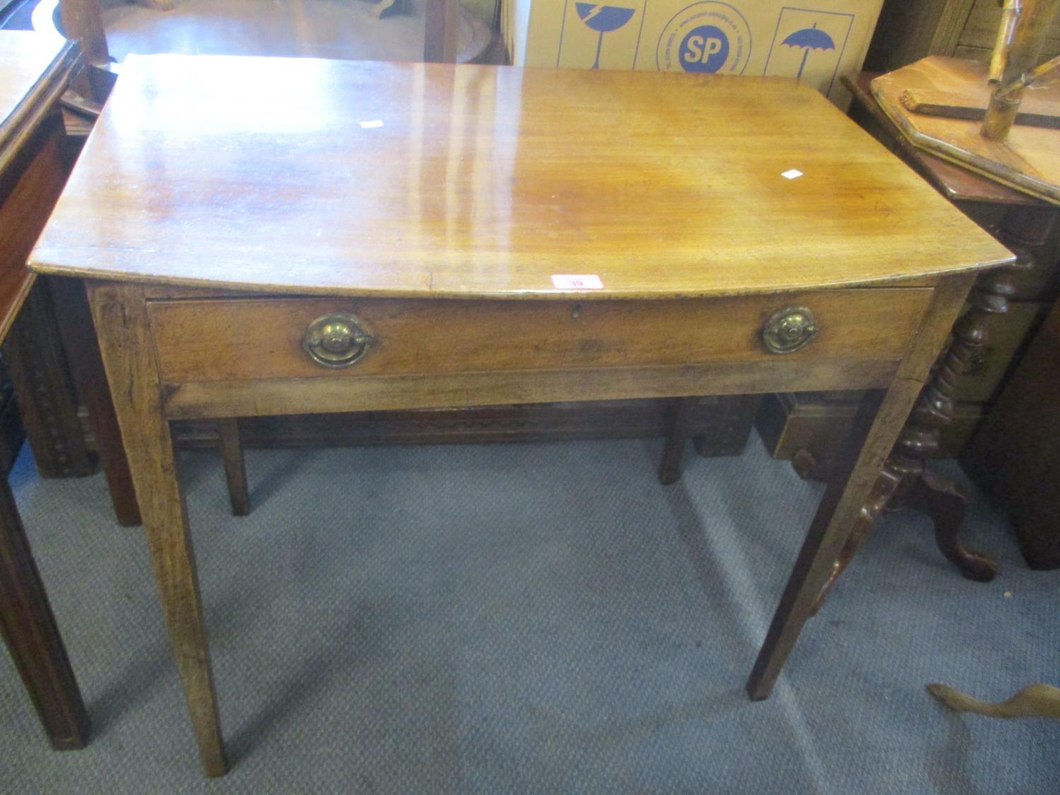 A Georgian bowl fronted side table having a single drawer and square, tapering legs, 28 1/2"h x 33"w