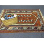 A vintage picnic basket and contents together with a woollen rug with Aztec border