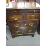 A reproduction straight fronted walnut chest of drawers with brushing slide above two short and