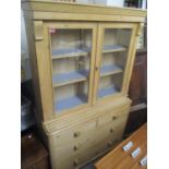 A Victorian pine dresser having twin glazed doors above two short and two long drawers, 74 3/4"h x