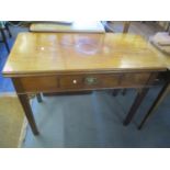 A Georgian mahogany tea table having a fold over top, single inset drawer and chamfered legs, 29"