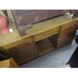 A Victorian pine sideboard having cushion moulded drawer flanked by two cupboard doors, 30 1/2" x 59