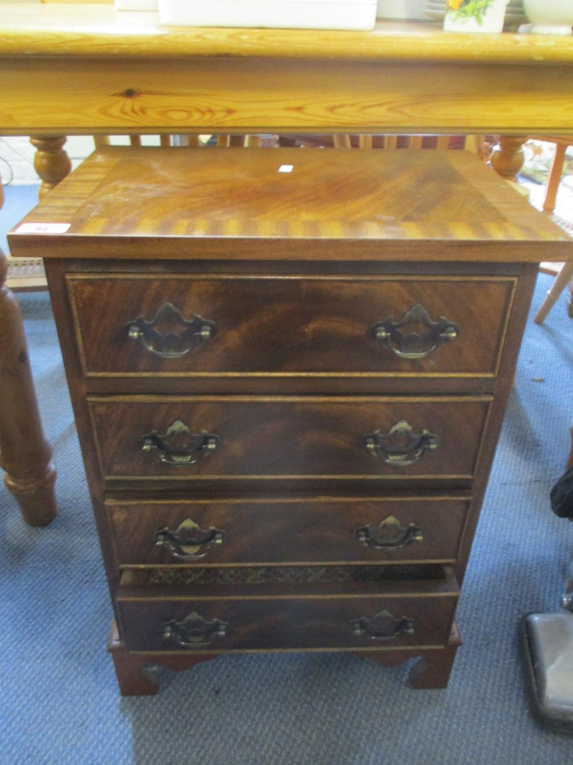 A reproduction mahogany small chest of four drawers on bracket shaped feet, 25" h x 17 1/2" w