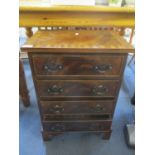 A reproduction mahogany small chest of four drawers on bracket shaped feet, 25" h x 17 1/2" w