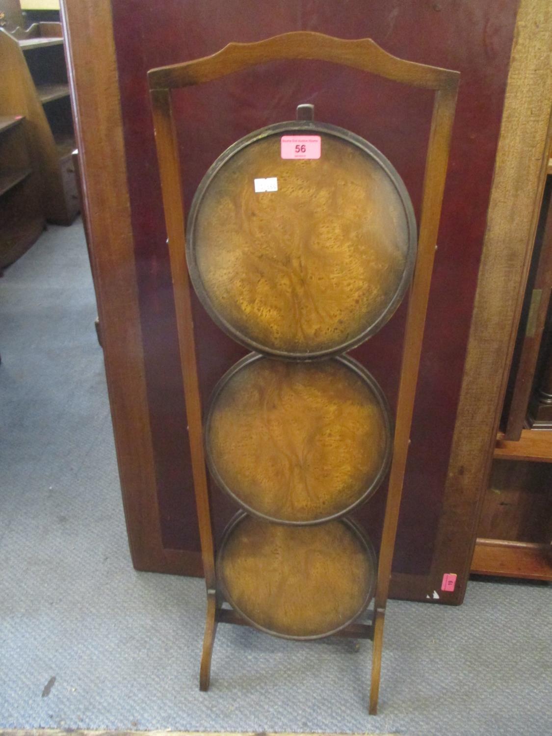 An early 20th century walnut three tier cake stand