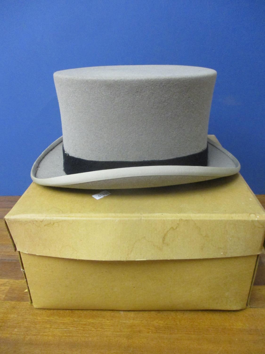 A Moss Brothers grey top hat with black band, size 7 1/2" and hat box