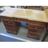 A Victorian mahogany twin pedestal desk having a leather top, nine drawers with bun shaped