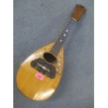 An Italian mandolin with mother of pearl inlay and label to the inside reading Paolo Rosetti Napoli