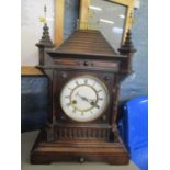 A late 19th century mahogany mantle clock of architectural form having flat shaped finials and white