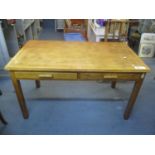 A mid 20th century light oak desk having two inset drawers and block shaped legs, 29 1/2" h x 53 1/